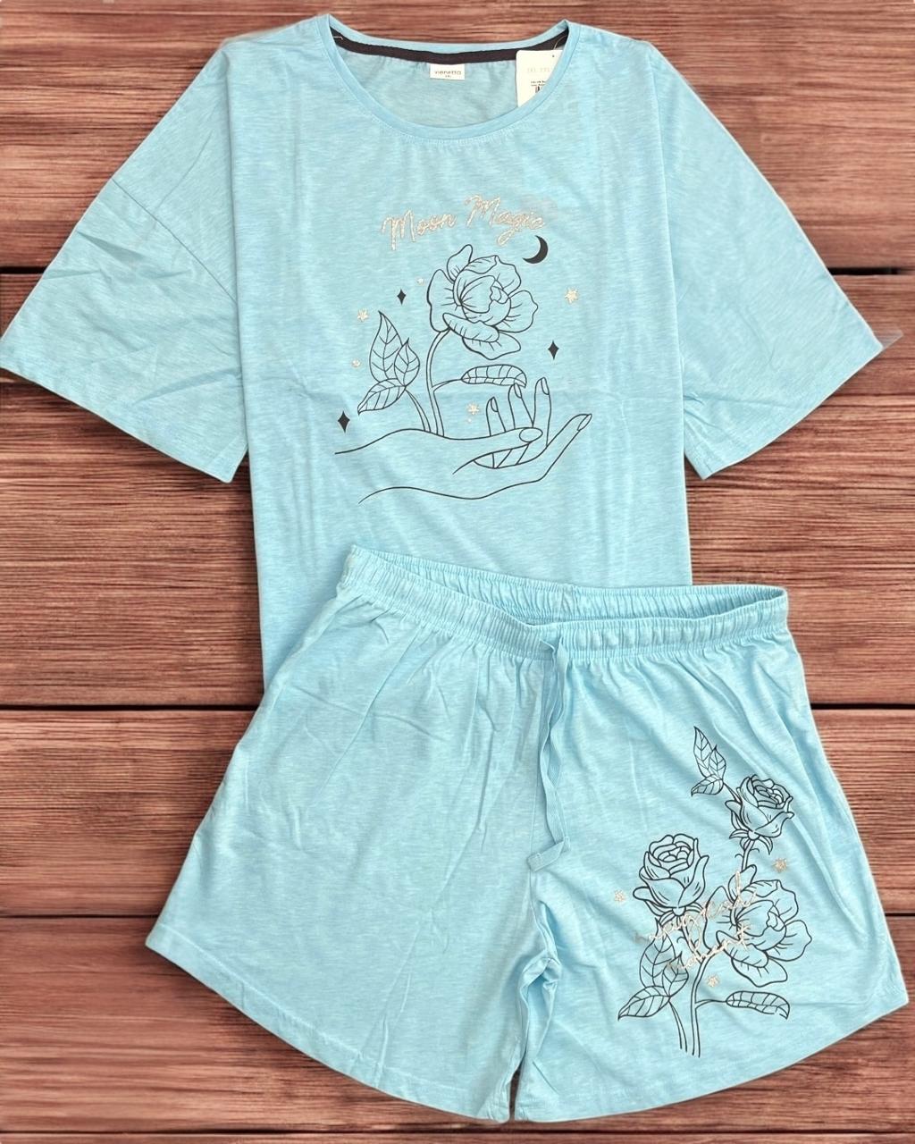 Light blue pajama set with floral designs on a wooden surface