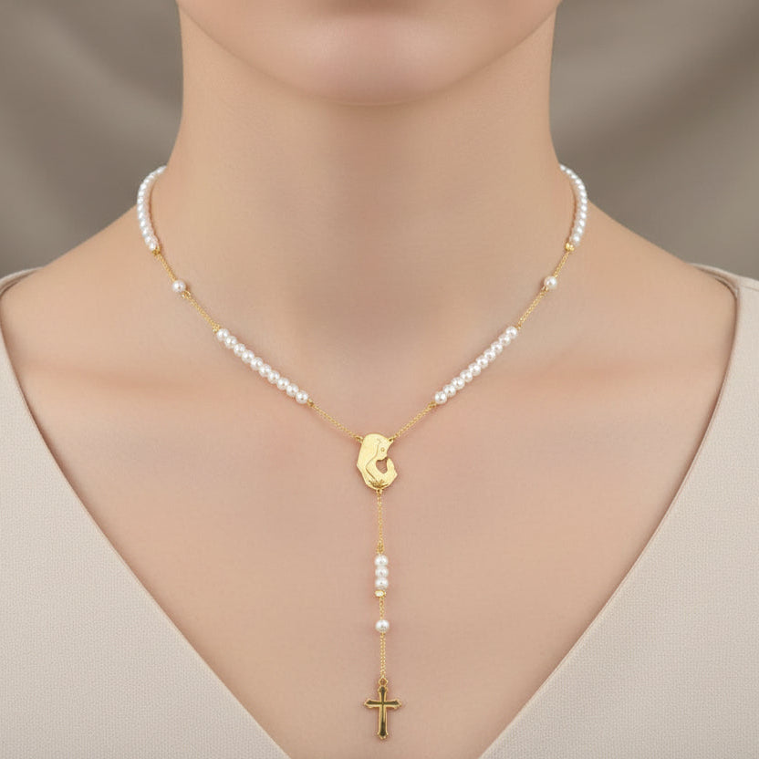 Pearl Mother Mary necklace with a gold cross worn by a woman