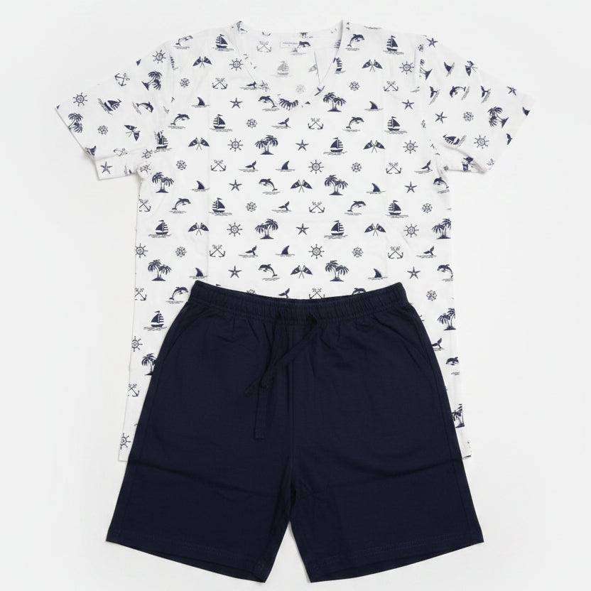 White sailboat and anchor print tee with navy shorts laid flat