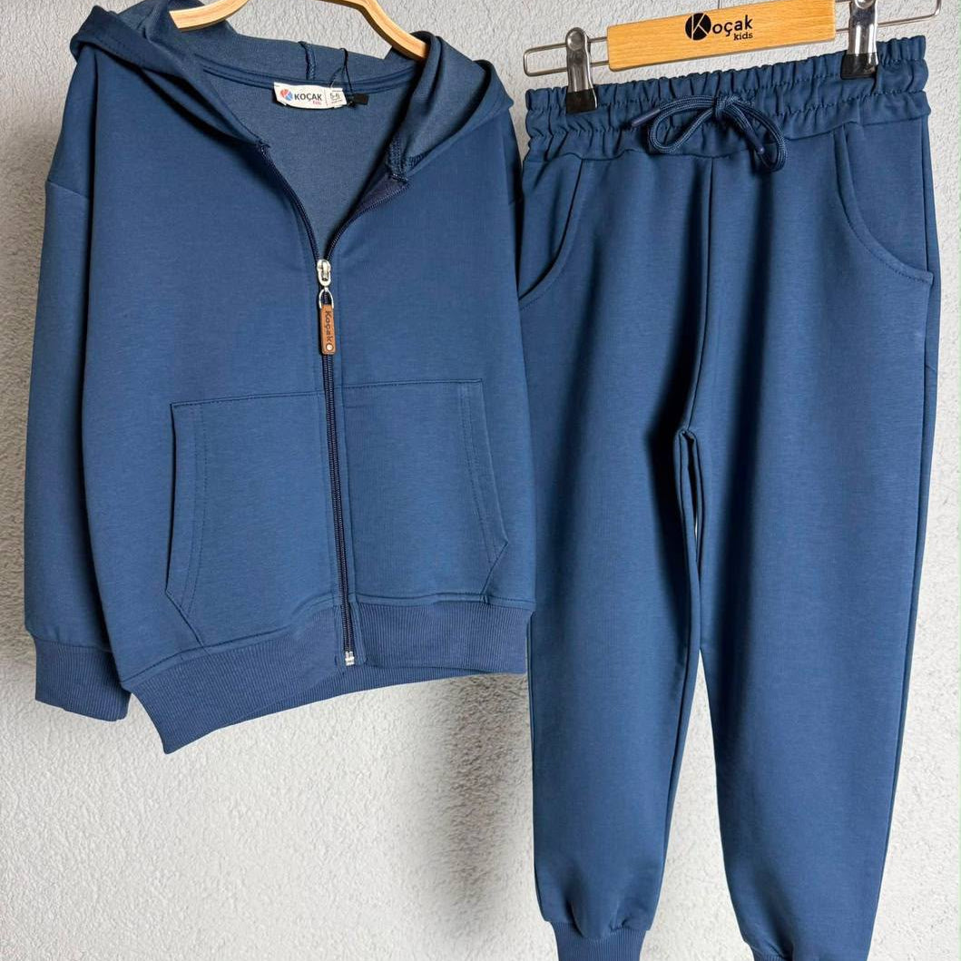 Blue zip hoodie and joggers hanging side by side on hangers