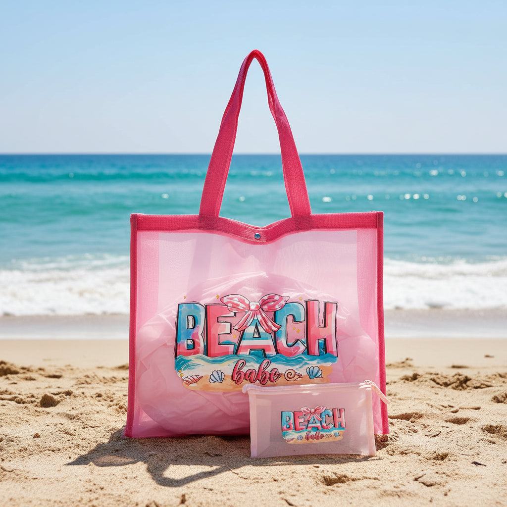 Pink tote bag with 'Beach Babe' text and a smaller pouch on a gray surface.