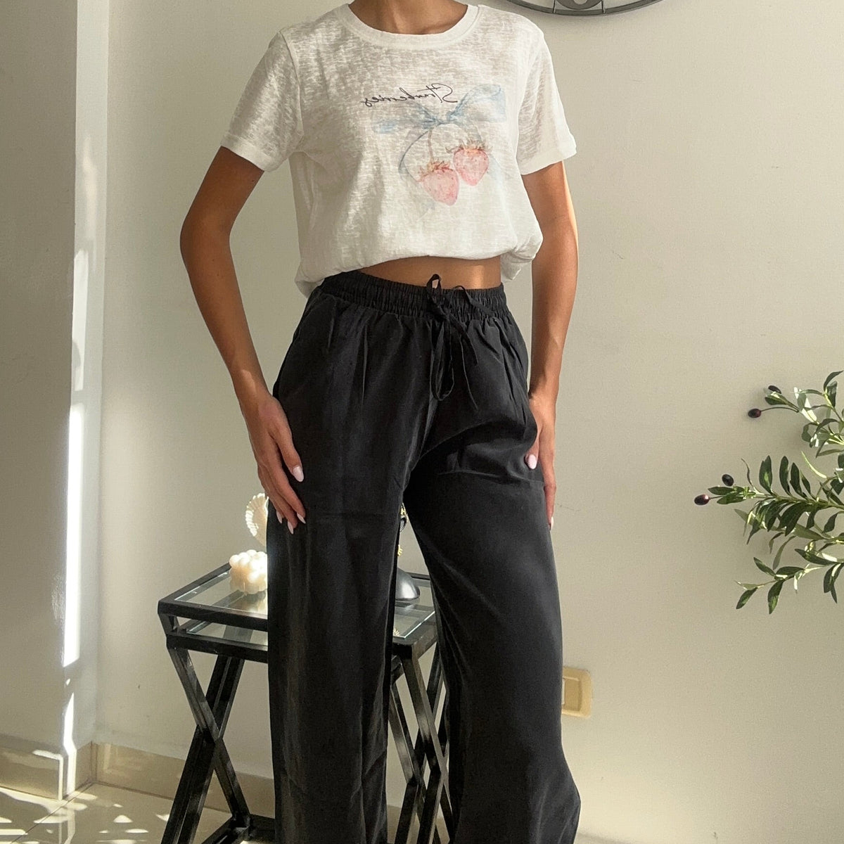 Pink floral crop tee tied at the waist with charcoal drawstring trousers