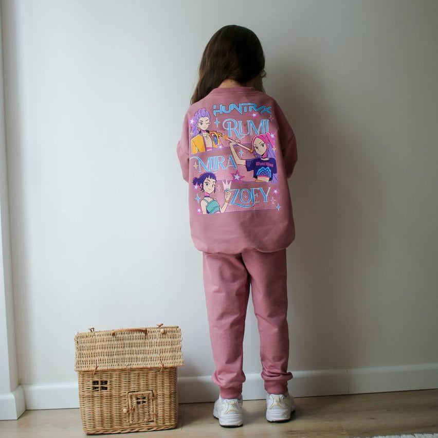 Back of a rose pink girls set showing the Huntrix band print with Rumi, Mira and Zoey