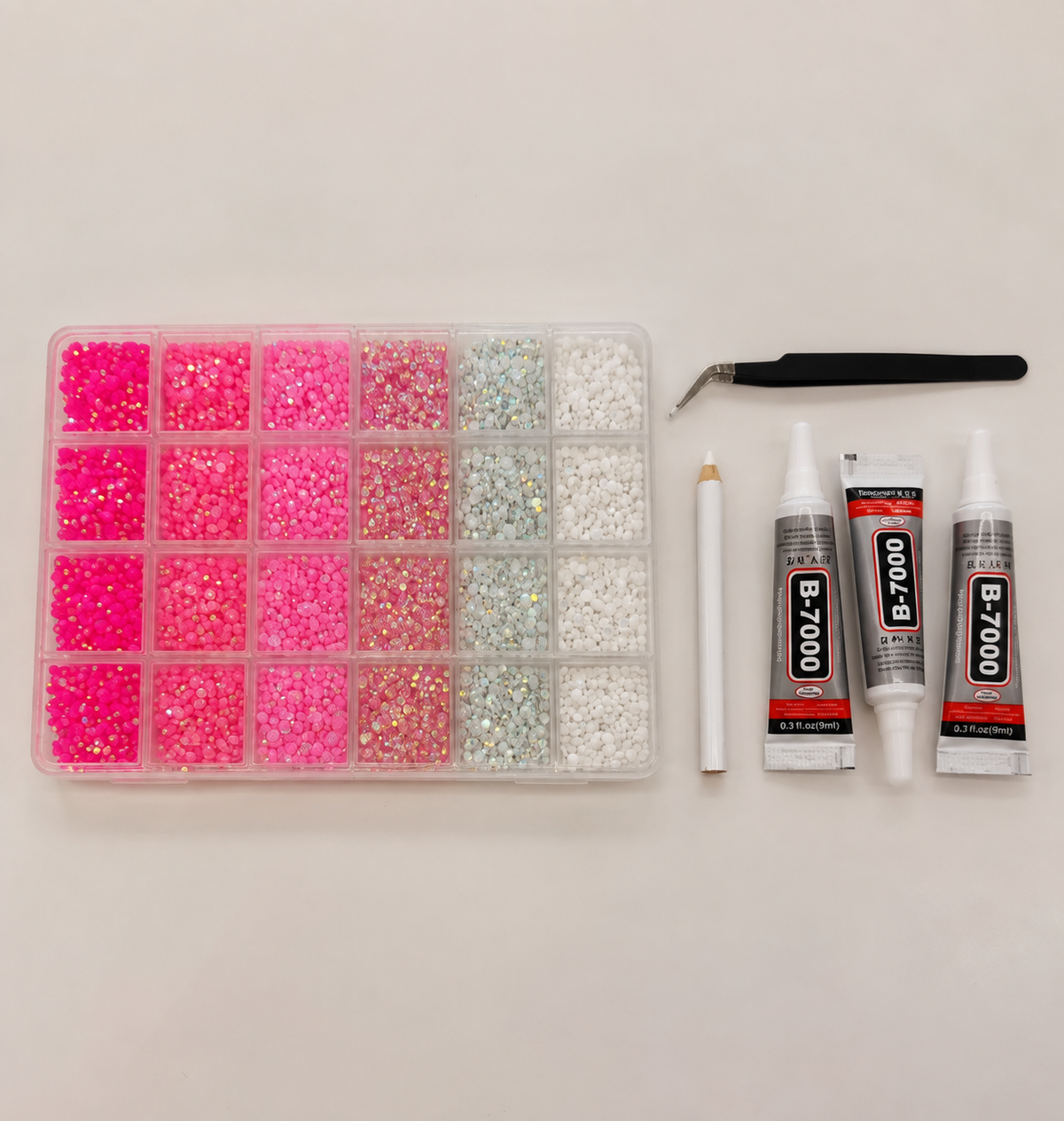Pink and white rhinestone craft kit box with tweezers, wax pencil and three glue tubes