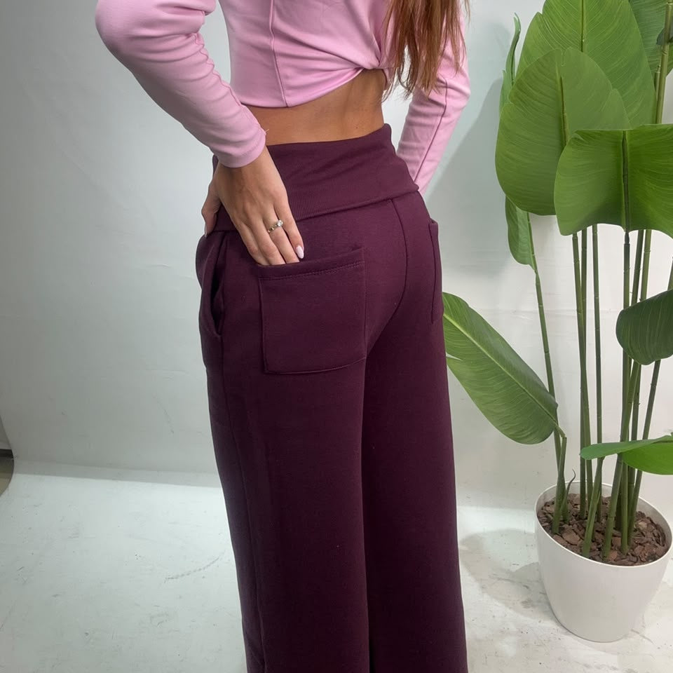 Back view of plum wide leg sweatpants with the fold over waistband