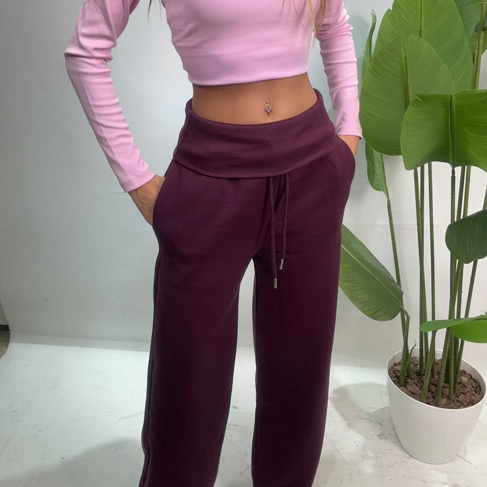 Close up of the folded ribbed waistband and drawstring on plum sweatpants
