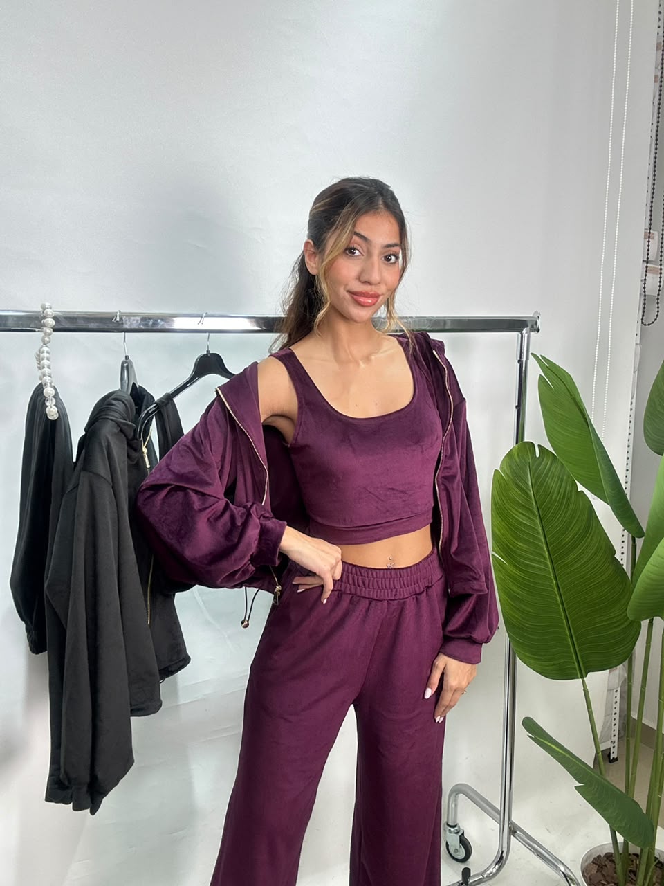 Front view of the plum velvet set with the jacket open over a scoop neck crop top