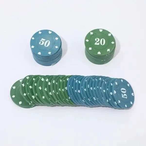 Fanned row of blue and green poker chips laid out behind two short stacks