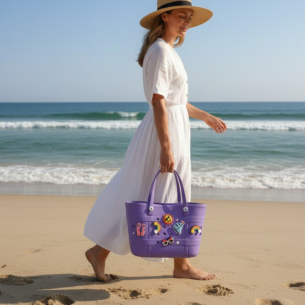 Woman in a white dress holding a purple beach bag with ocean waves in the background