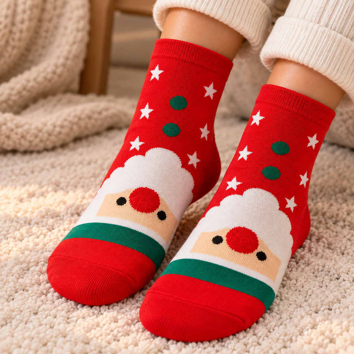 Red Christmas socks with green dots and stars and a white bearded Santa face above a green band