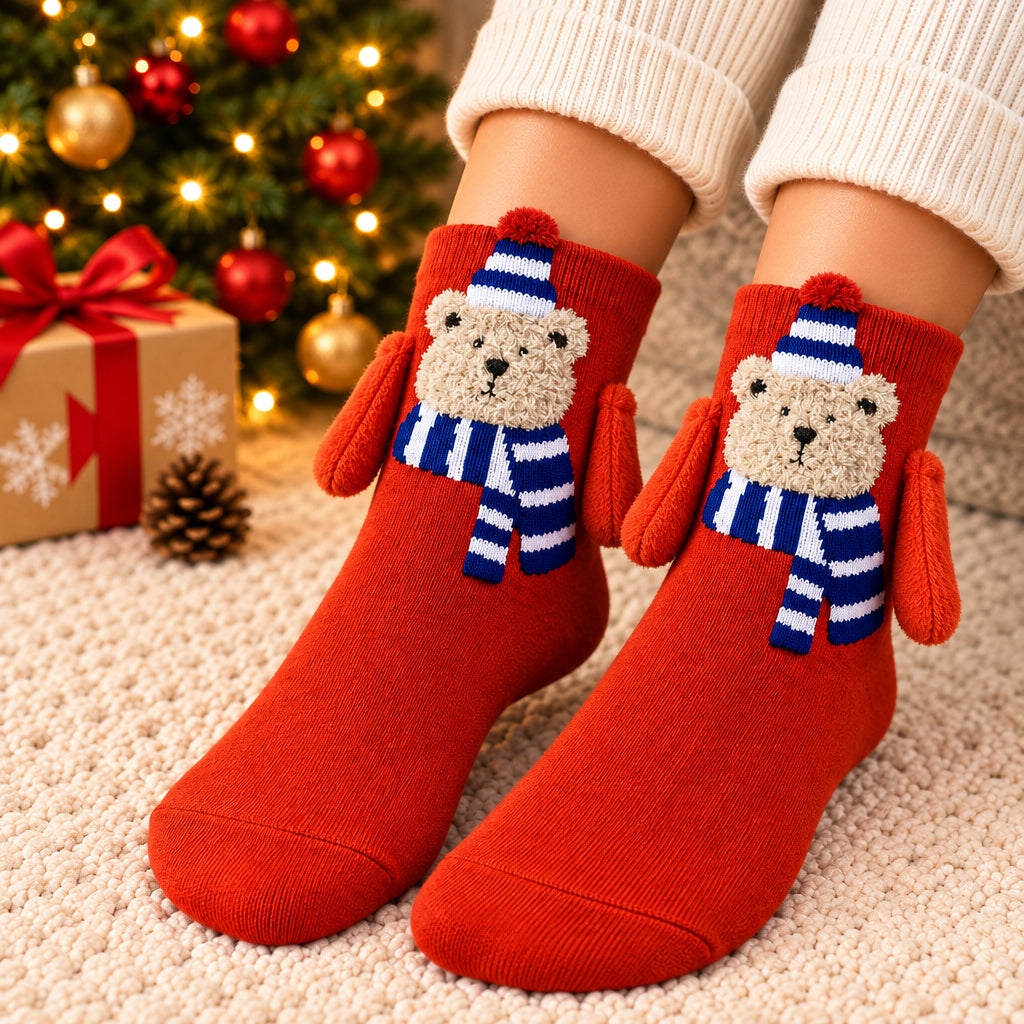 Red Christmas socks with a fuzzy bear in a blue striped hat and scarf and orange plush arms