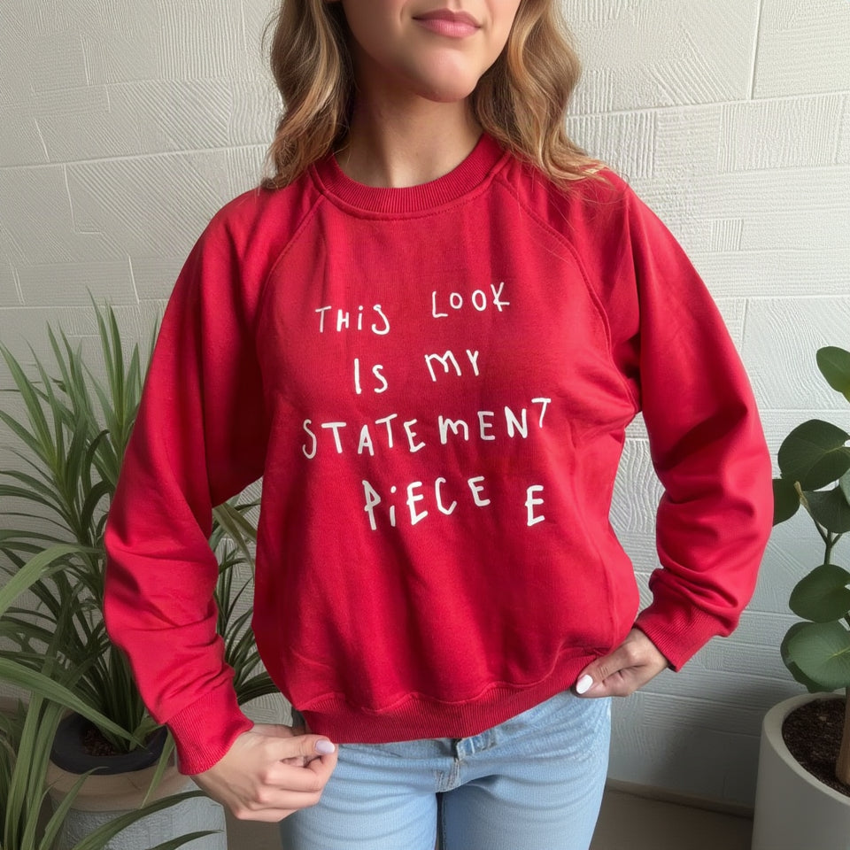 Red raglan sweatshirt with white This look is my statement piece lettering, worn with light jeans