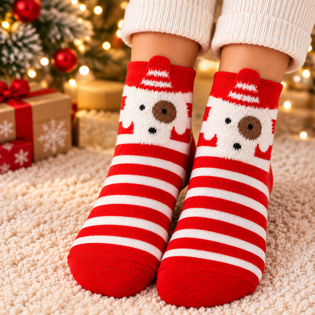 Red and white striped Christmas socks with a white puppy face at the cuff, worn by a Christmas tree