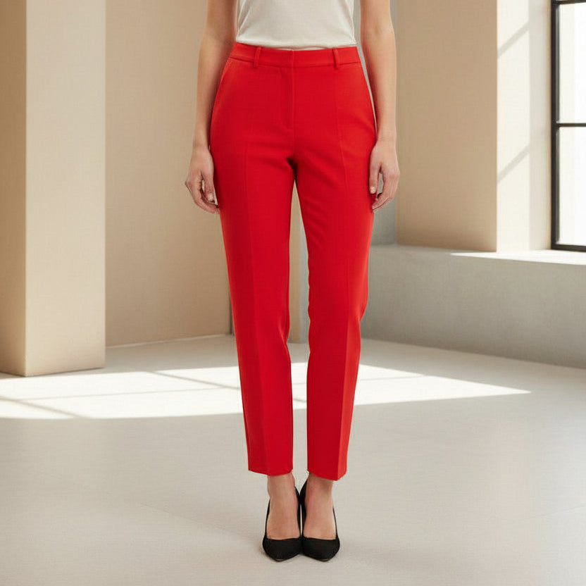 Person wearing red pants in a minimalistic room with a window
