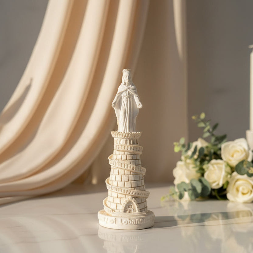 Ivory resin Our Lady of Lebanon statue on a brick tower with a spiral outer stair