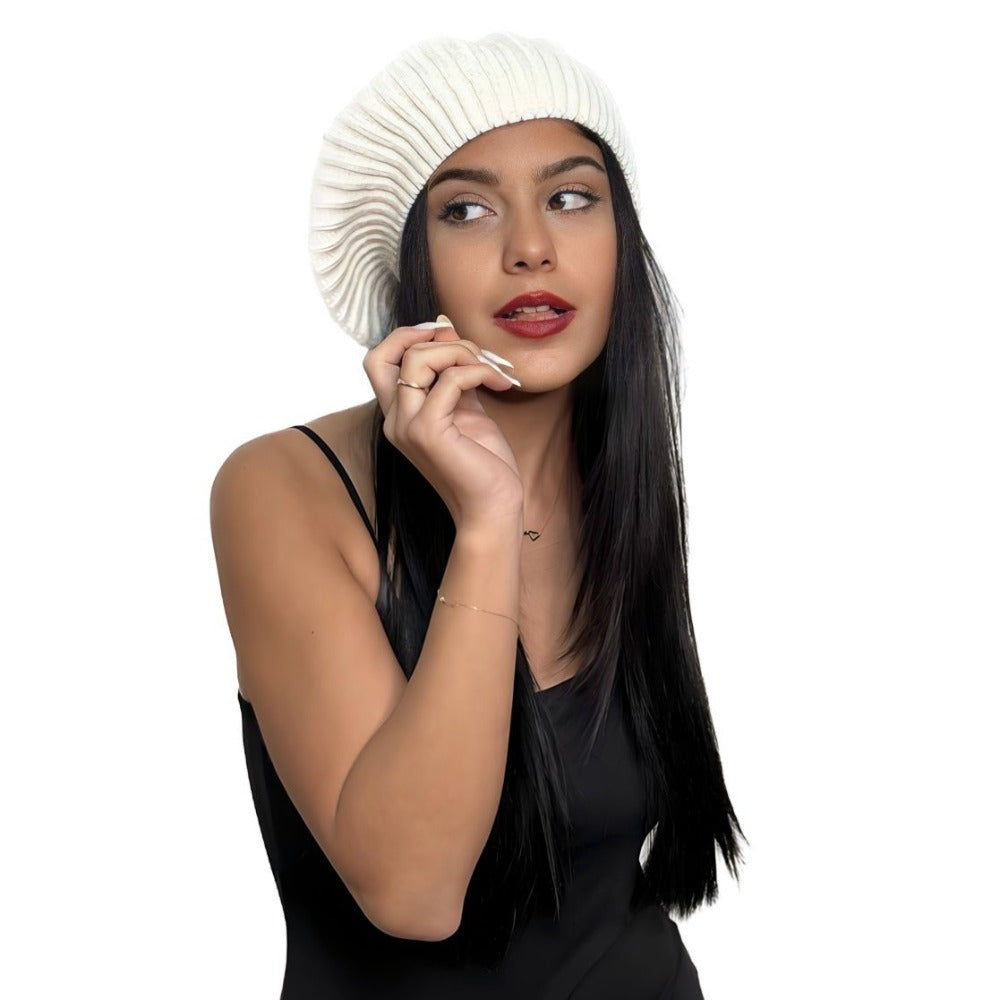 White wool beret worn with a hand to the face