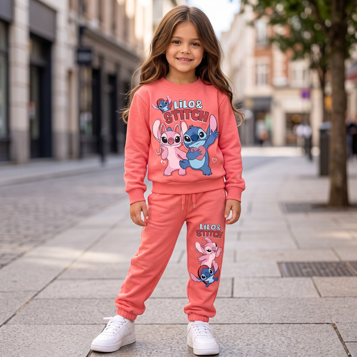 Girl in a coral stitch sweatshirt with matching coral joggers and white trainers