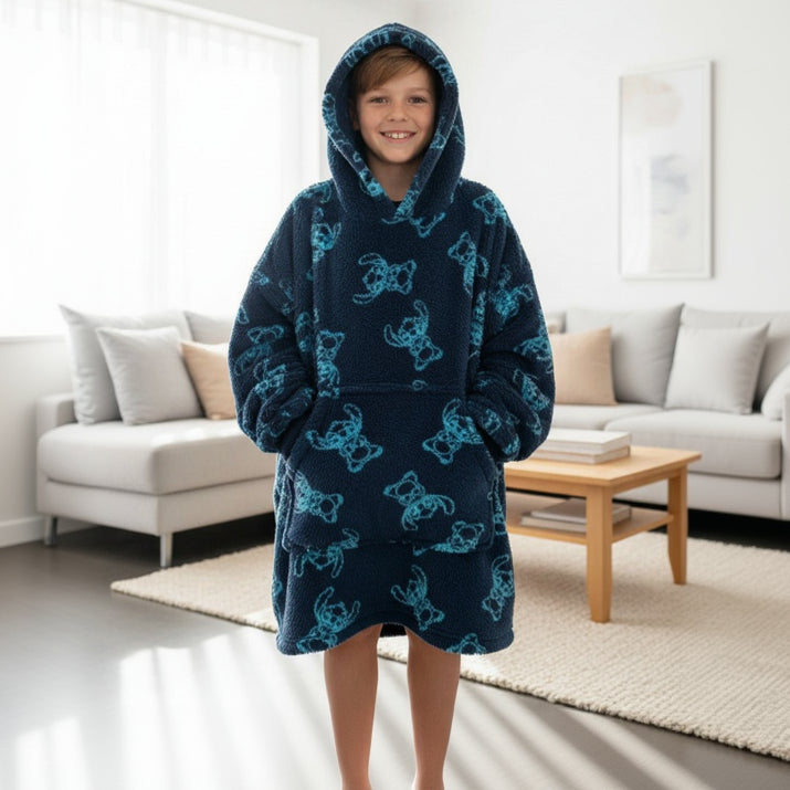 Child in a navy Stitch print hooded blanket standing in a living room