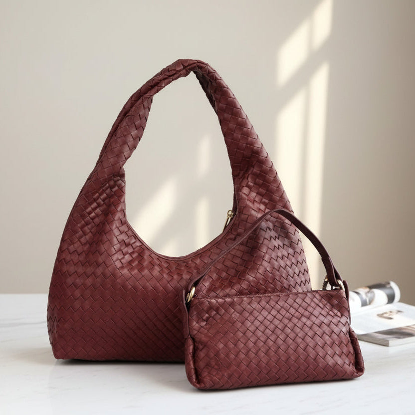 Red woven handbag on a light surface with a neutral background