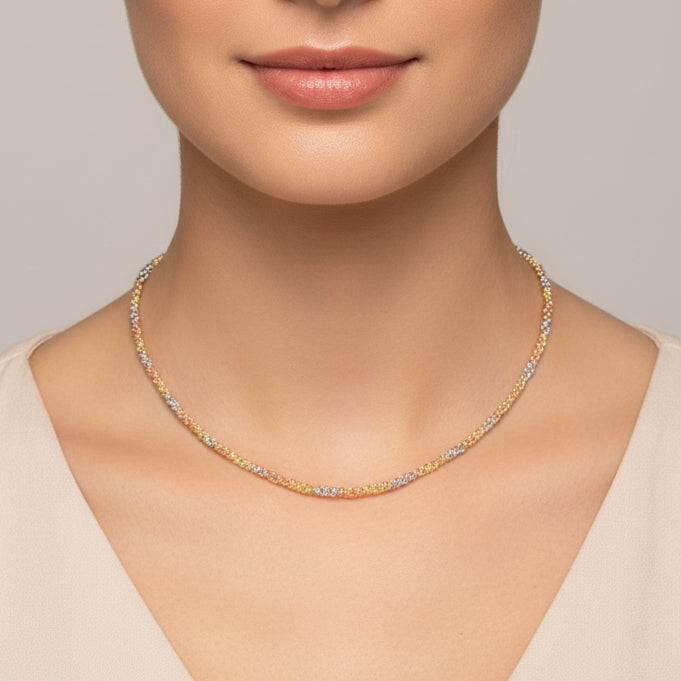 Tri-tone beac necklace with gold and silver beads worn by a person on a white background