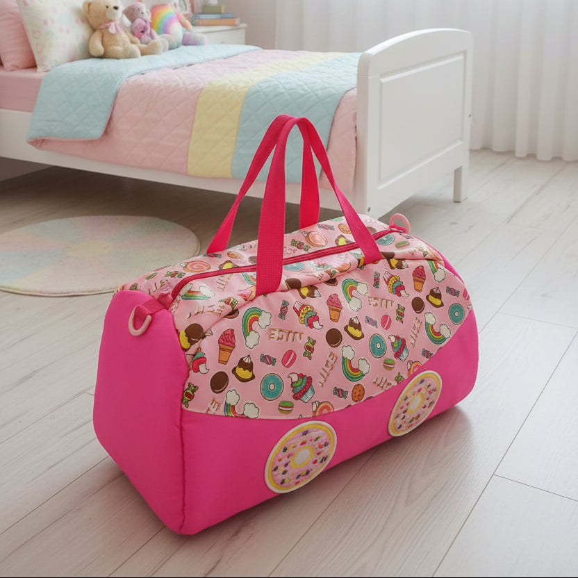 Pink duffel bag with candy-themed design on a wooden floor in a child's bedroom.