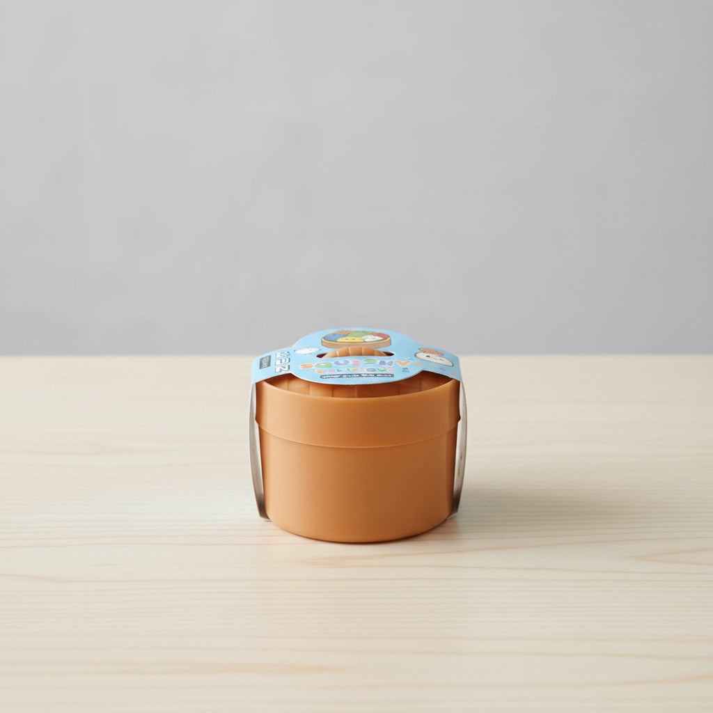 Small terracotta pot with a label on a light wooden surface and gray background