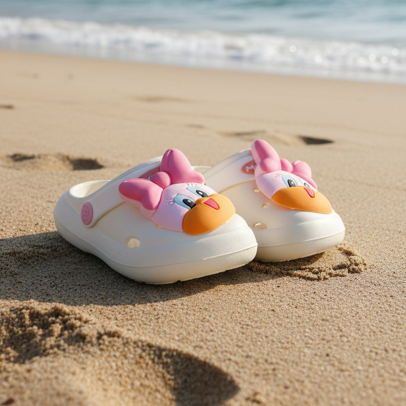 Children's shoes with cartoon face design on a white surface