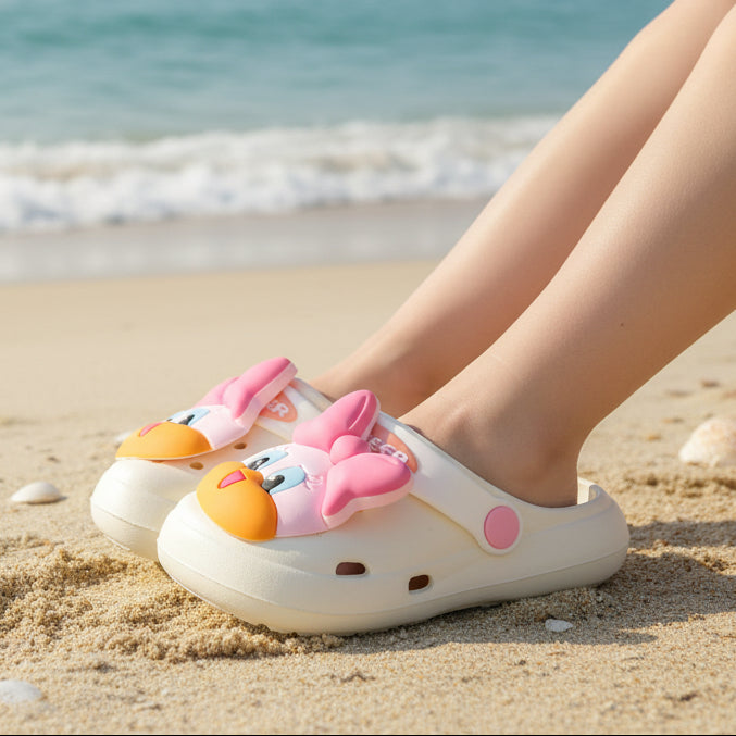 Children's shoes with cartoon face design on a white surface
