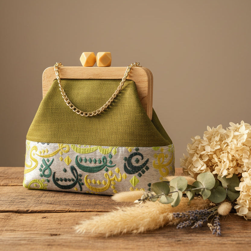 Green handbag with floral pattern on a glass surface, with a store interior in the background.