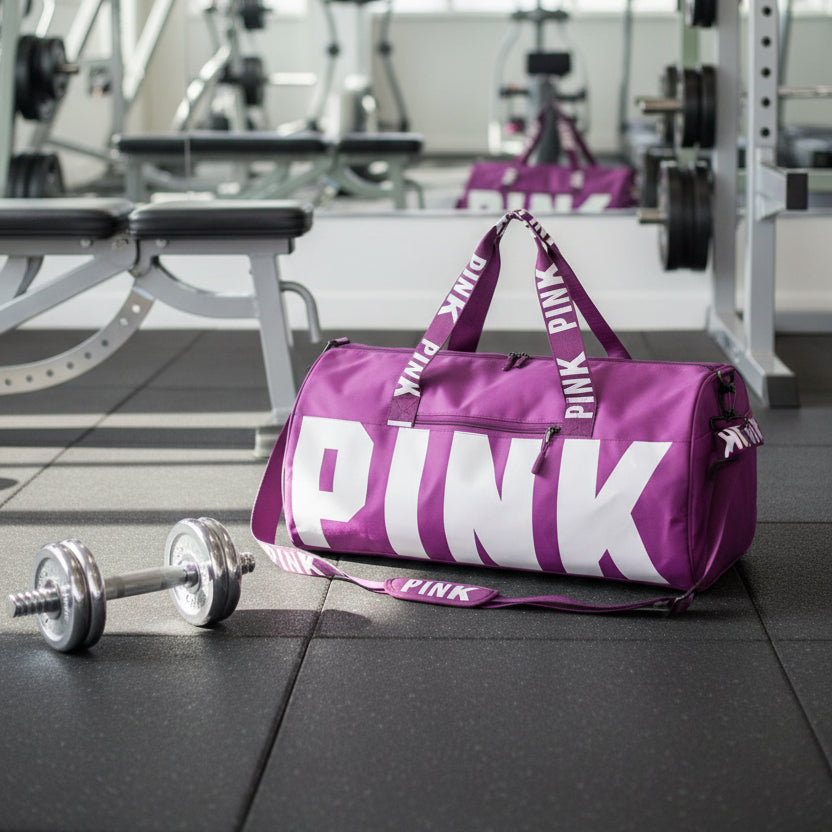 Purple duffel bag with 'PINK' branding on a gray background