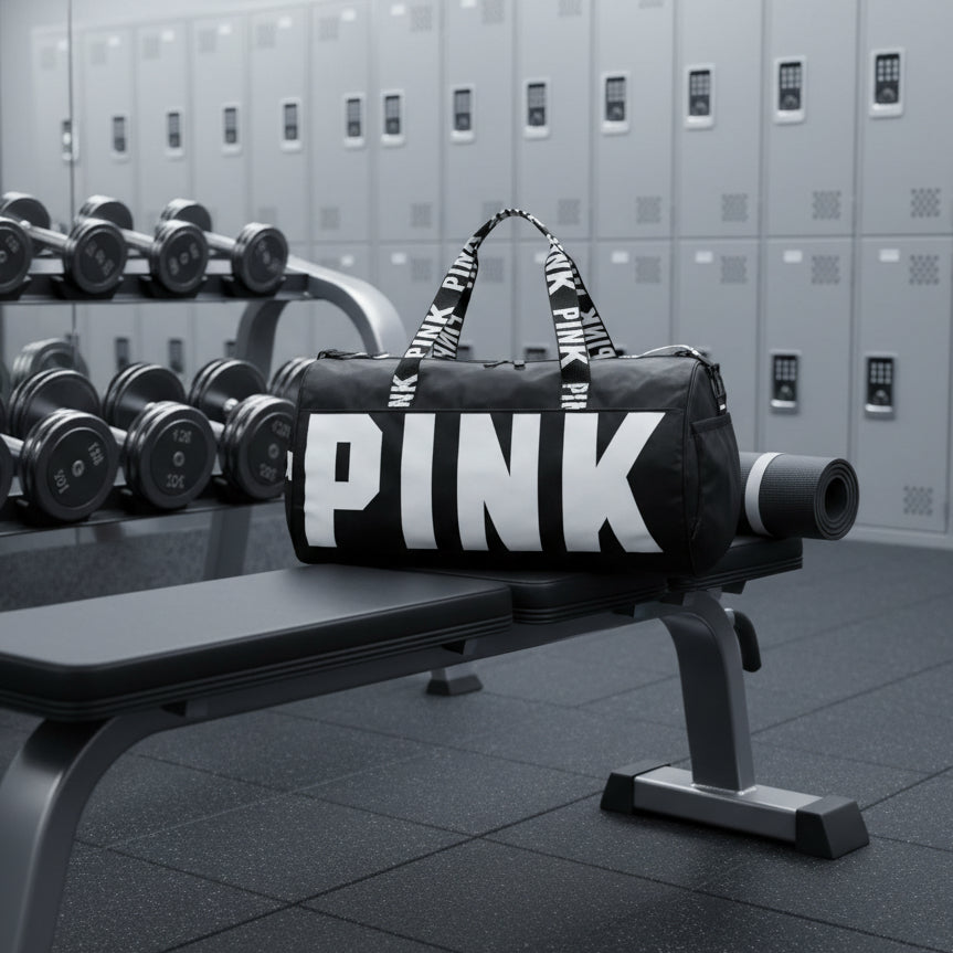 Black duffel bag with 'PINK' branding on a gray background