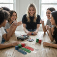Friends around a table with the chip tin, rows of poker chips and a dealer button