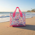 Transparent tote bag with cartoon designs on a beach