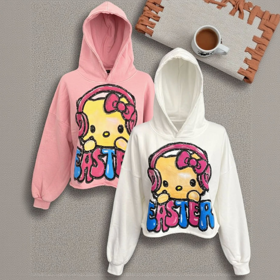 Pink and white hoodies with cartoon character and 'Easter' text on a gray surface