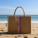 Beige tote bag with measurements on a sandy beach