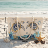 Beach bag with turtle design on sand by the ocean
