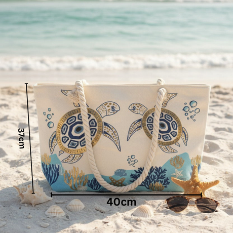 Beach bag with turtle design on sand by the ocean