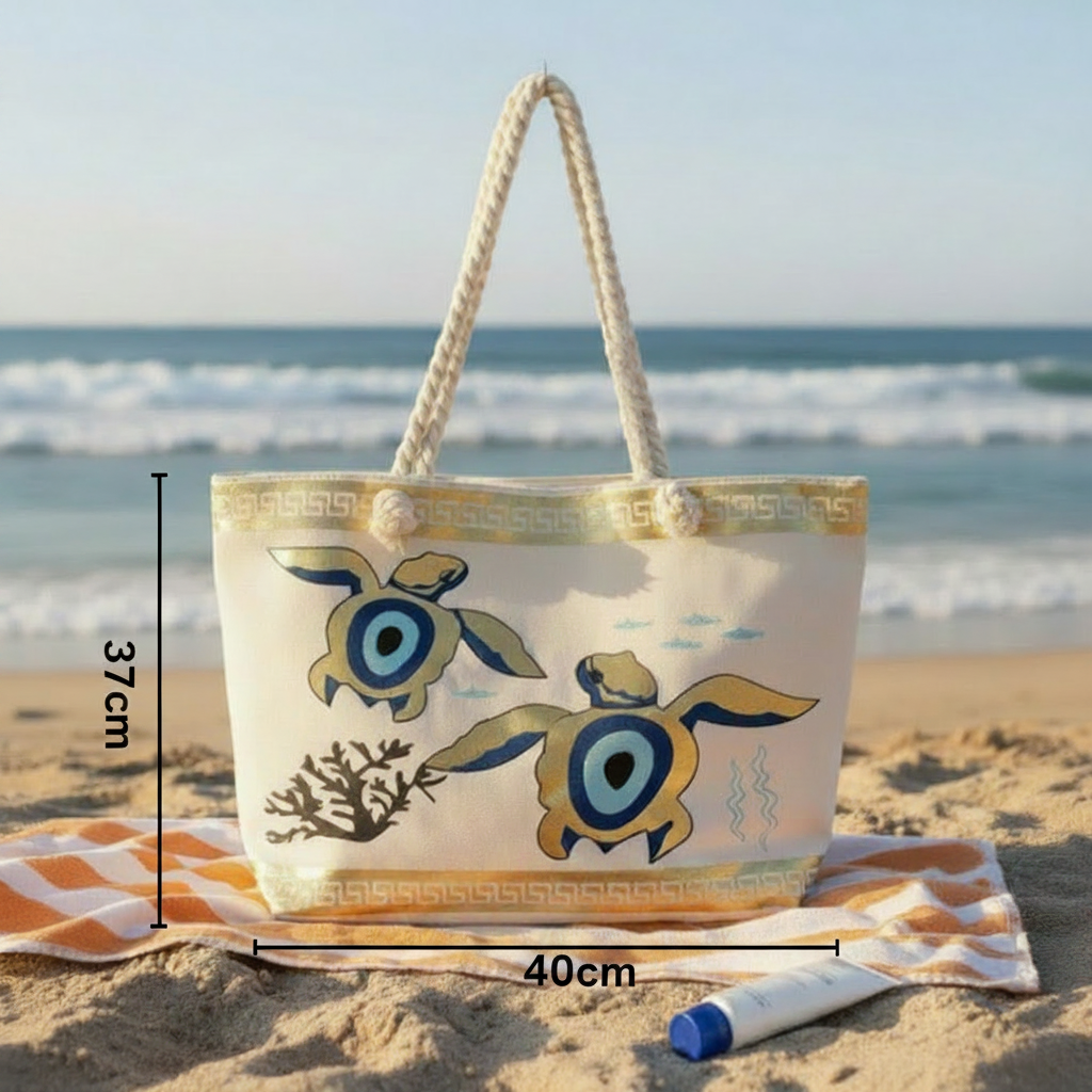 Beach bag with turtle design on sand by the ocean