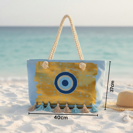 Beach bag with rope handle on a sandy beach with ocean view, featuring measurements.
