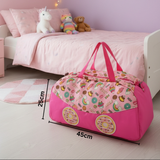 Pink duffel bag with candy-themed design on a wooden floor in a child's bedroom with dimensions.