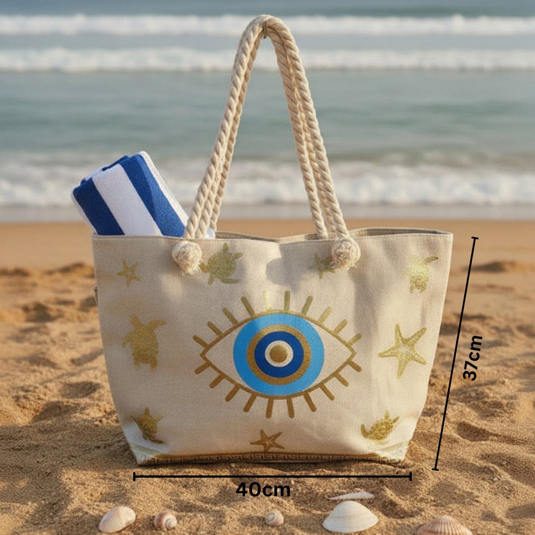 Beach bag with eye design on sand by the ocean
