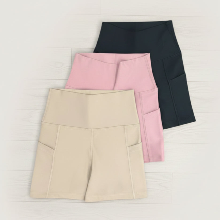 Beige, Pink and Black pocket biker shorts on a white background