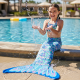 Girl wearing a three piece mermaid swimsuit with a shimmering tail at the pool