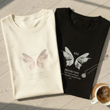 Two folded shirts with butterfly designs on a wooden floor.