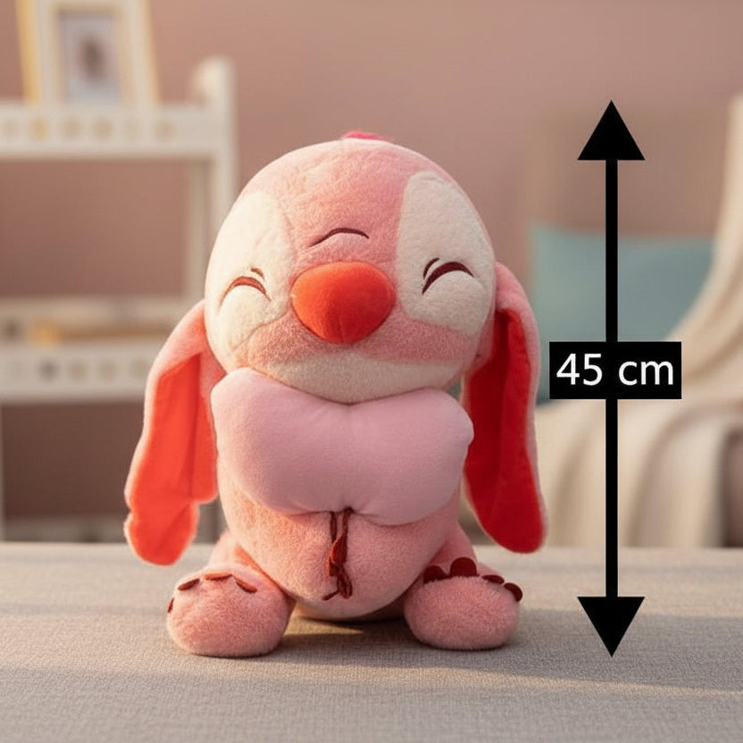 Coral pink hugging character plush on a taupe surface in a warm blush room, 45cm