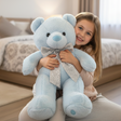 Powder blue teddy bear with a large silver glitter bow and long ribbon tails