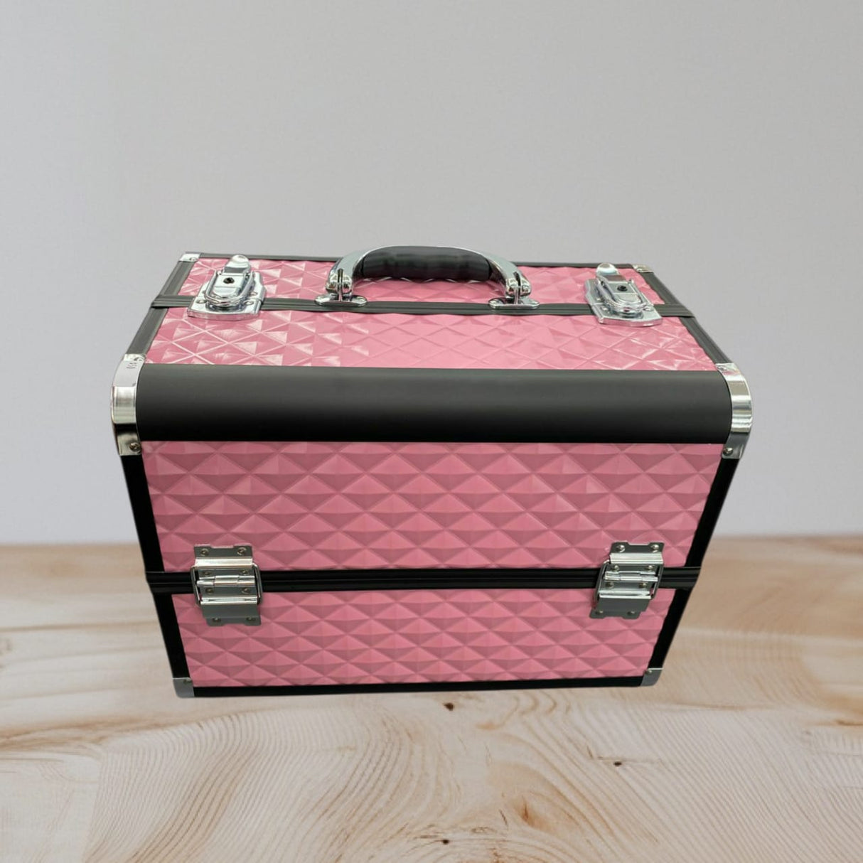 Pink quilted aluminium makeup case closed with black rails, chrome corners and latches