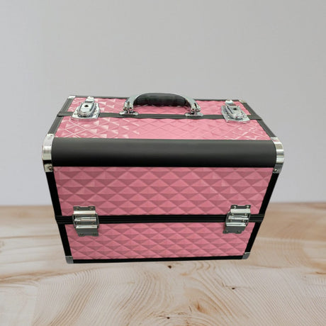 Pink quilted aluminium makeup case closed with black rails, chrome corners and latches