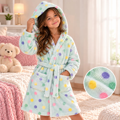 Girl in a mint fleece robe with pastel polka dots, hood up and belt tied, with a fabric close up