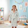 Girl wearing a mint polka dot hooded kids robe